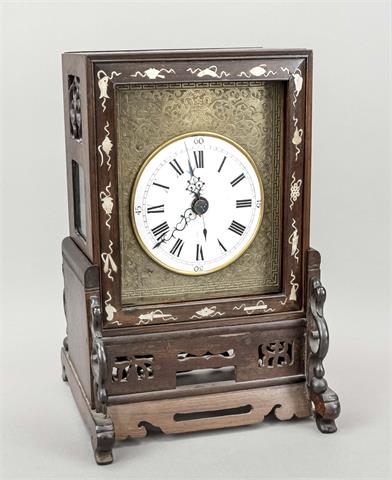 A mahogany table clock with mother-of